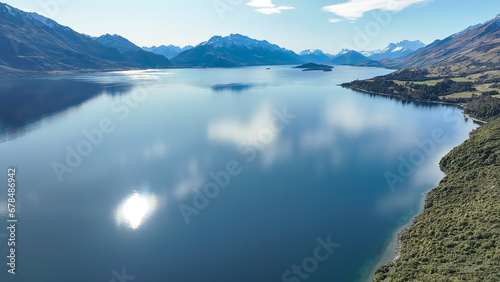 Dreamy aerial view from a mavic drone of the shoreline  of lake Wakatipu and its surrounding mountain ranges photo