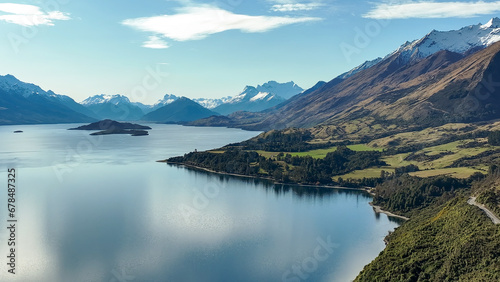 Dreamy aerial view from a mavic drone of the shoreline of lake Wakatipu and its surrounding mountain ranges