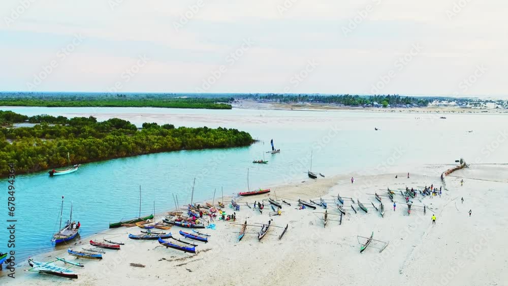 Beautiful African Harbor scenery with people and pirogues. Aerial view of boats sailing the blue azure river. Ships leaving the port. Green coast. Calm African Landscape scenery. Beautiful African Harbor scenery with people and pirogues. Aerial view of boats sailing the blue azure river. Ships leaving the port. Green coast. Calm African Landscape scenery.