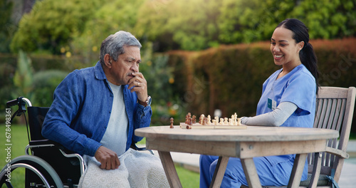 Happy woman, nurse and senior playing chess in nature for elderly care, match or thinking in strategic game. Female, medical caregiver or person with a disability contemplating next move on board photo