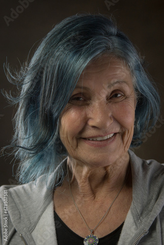 radiant senior woman is embracing her age and individuality with her stylish blue hair. She's a reminder that you're never too old to have fun and express yourself