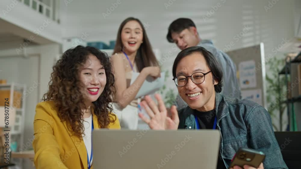 Happy businesswomen and businessman teamwork friend waving to someone during a conference call over laptop at casual office Cheerful colleagues posing for a selfie in casual office Happy businesswomen and businessman teamwork friend waving to someone during a conference call over laptop at casual office Cheerful colleagues posing for a selfie in casual office