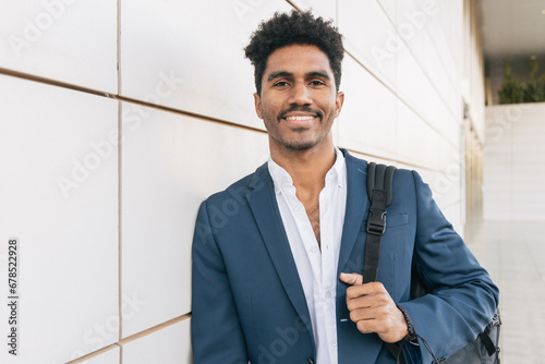 Smiling ethnic man with backpack