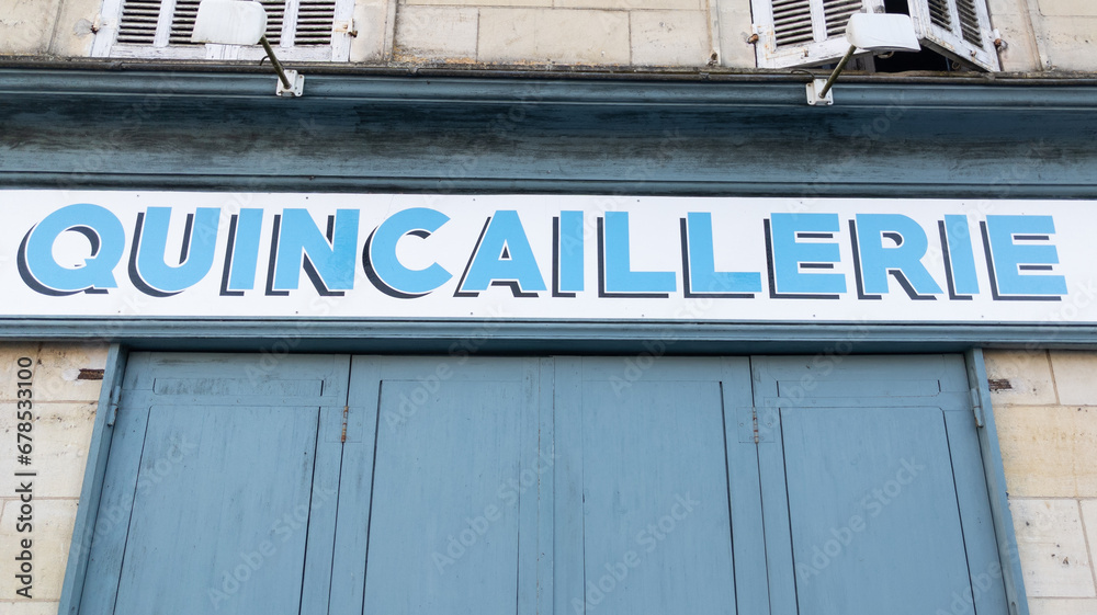 Quincaillerie french text sign means Hardware store on facade old store closed entrance