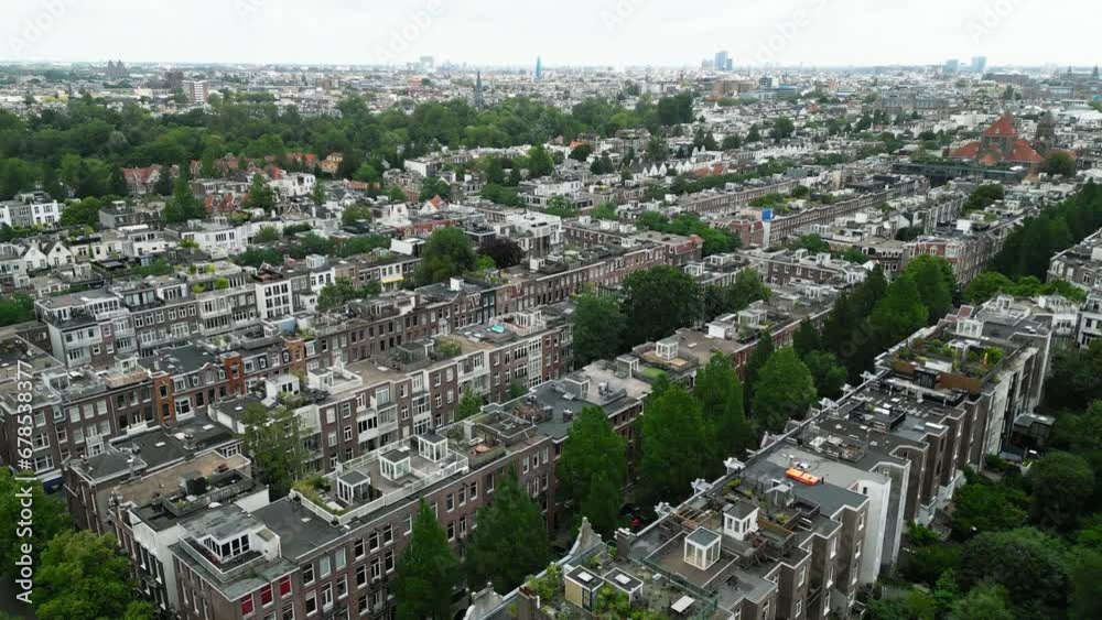 The densely built-up part of the city successfully combined with green old trees, rising between the long rows of houses on narrow streets with parked cars. High quality 4k footage The densely built-up part of the city successfully combined with green old trees, rising between the long rows of houses on narrow streets with parked cars. High quality 4k footage