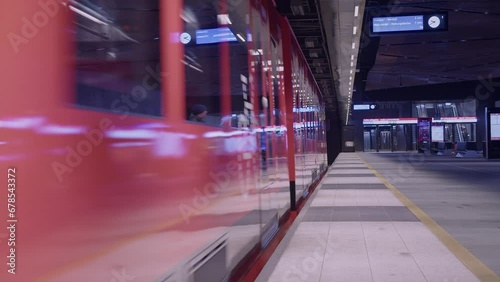 Public transit train departs underground subway station in modern city photo