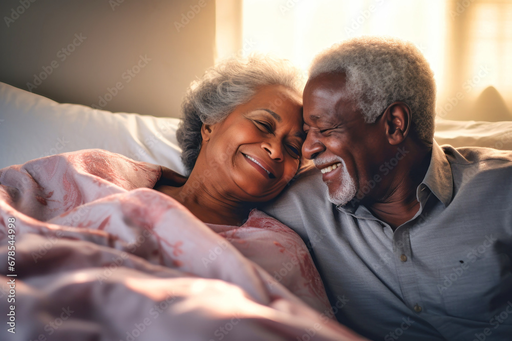 A loving dark-skinned elderly couple, a man and a woman, in bed in the morning. Love and romance of two people. Tenderness and relaxation. Happy morning for lovers. Valentine's Day. A loving dark-skinned elderly couple, a man and a woman, in bed in the morning. Love and romance of two people. Tenderness and relaxation. Happy morning for lovers. Valentine's Day.