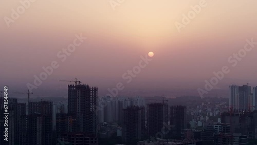 Aerial shot cityscape with buildings and  at dawn or dusk in Delhi, India. Development of real estate spaces in India.