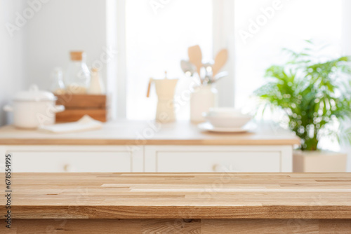 Empty wooden table for product display on blurred kitchen counter interior background photo