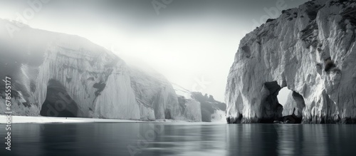 Black and white portrait taken under the white cliffs of Rugen with clear blue water photo