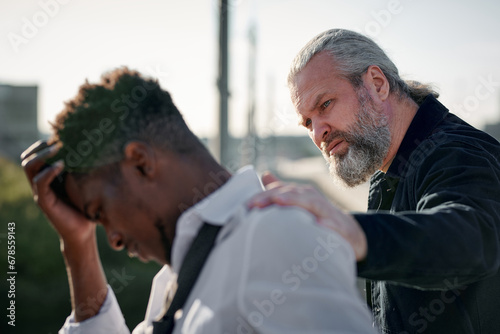 Mature man talking to guy in depression and trying to help him in his problems