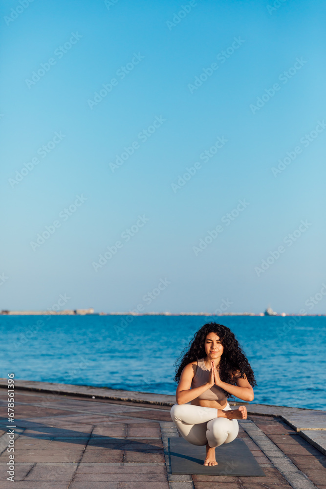 Beautiful girl relaxing by the sea. Calm, serene, minimalist photo with copy space