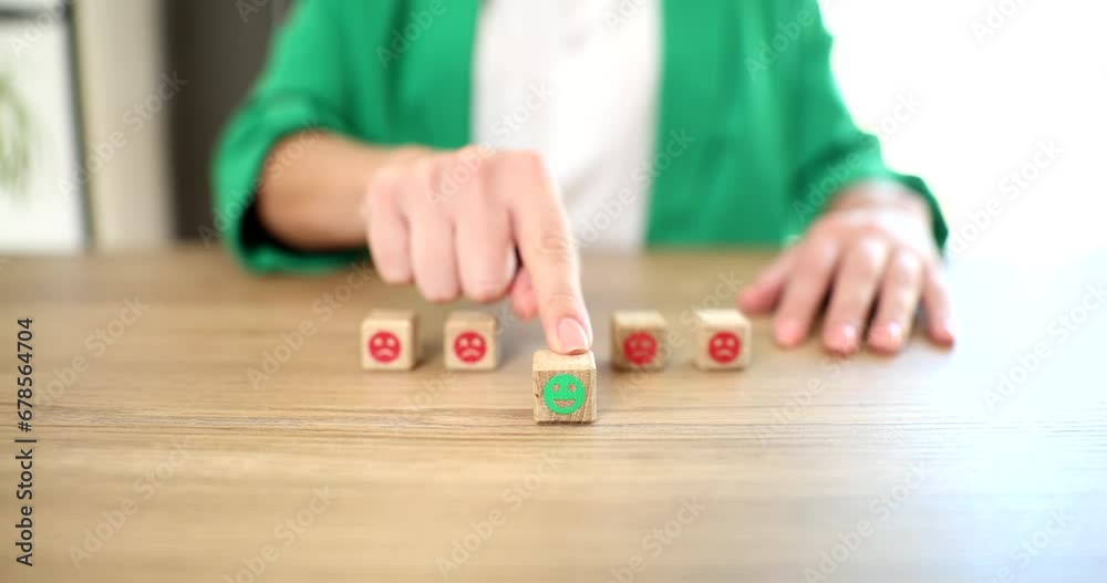 Customer service satisfaction survey concept. Customer hand chooses happy smiley face on wooden cube for feedback survey and business Customer service satisfaction survey concept. Customer hand chooses happy smiley face on wooden cube for feedback survey and business