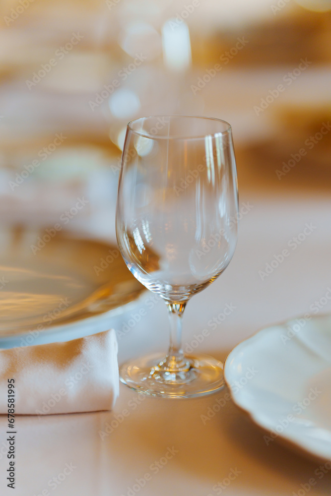 An empty wine glass on a table served for a banquet. An empty wine glass on a table served for a banquet.