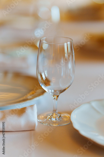 An empty wine glass on a table served for a banquet. 