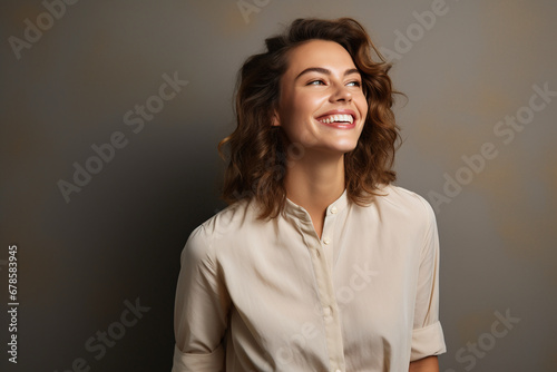 Radiant Glow: Happy Young Woman Gazing Away with a Joyful Smile, Standing Confidently in a Studio Background, Capturing a Moment of Contentment