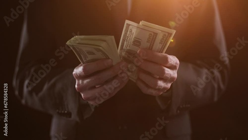 Hands of a financial worker counting money bills. A large bundle of money close-up. photo
