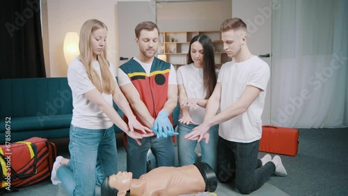 First aid resuscitation, CPR training. Students study in front of a dummy. Medicine, healthcare and medical concept photo
