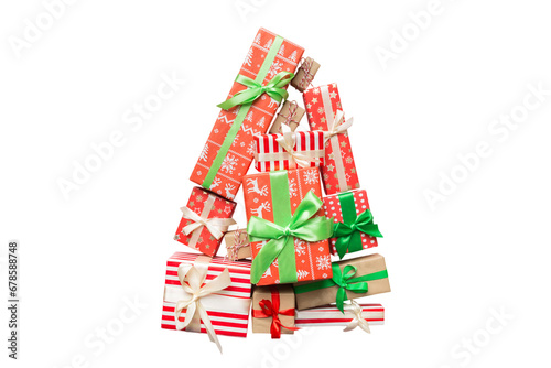 Isolated Christmas tree made of beautifuly wrapped presents on colored background, view from above. New Year gift box minimal concept photo