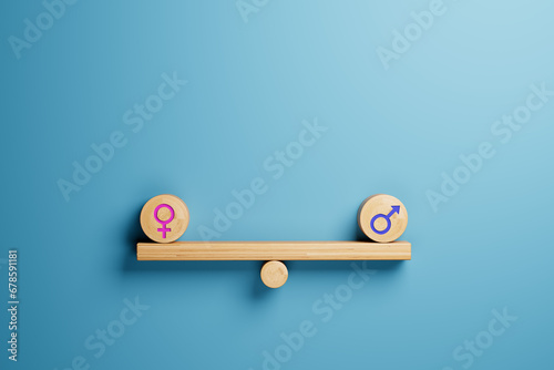 Gender equality concept male and female symbol balancing on wooden seesaw photo
