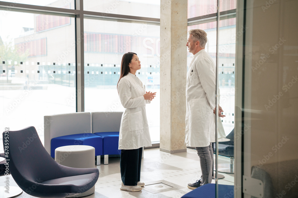 Doctors having discussion in laboratory lobby