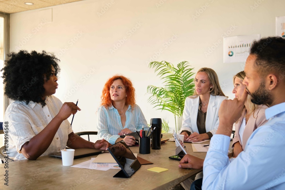 Fototapeta premium African business woman discussing economic results with her coworkers at a meeting.