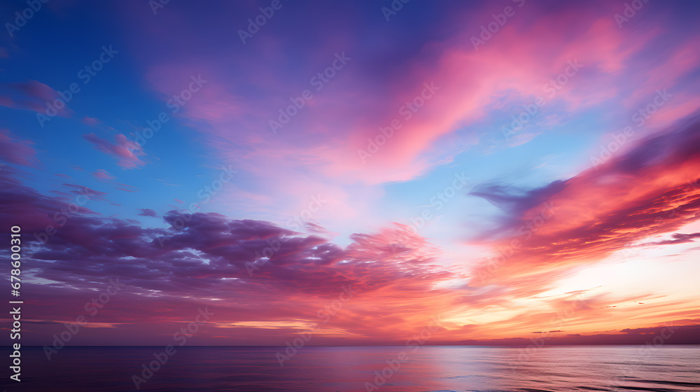 An awe-inspiring photograph capturing the brilliant color gradient of a sunset sky, transitioning from fiery red and orange to cool shades of violet and indigo.