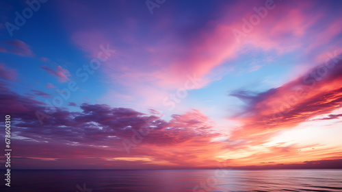 An awe-inspiring photograph capturing the brilliant color gradient of a sunset sky, transitioning from fiery red and orange to cool shades of violet and indigo. © CanvasPixelDreams