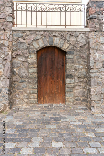 Fototapeta Naklejka Na Ścianę i Meble -  wooden door in stone wall