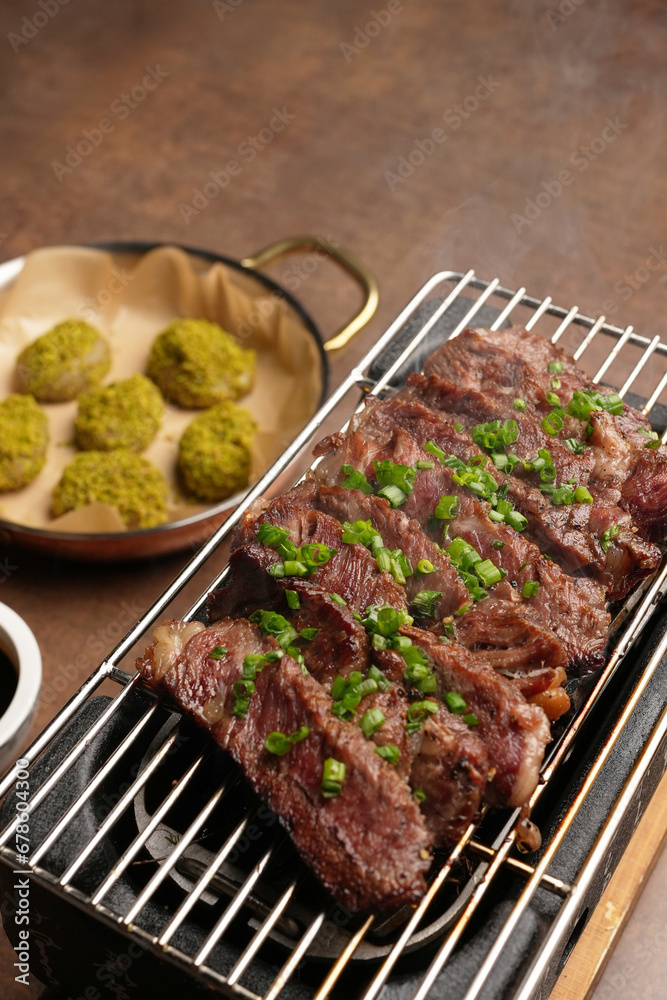 Grilled striploin beef steak served on grill, indoors