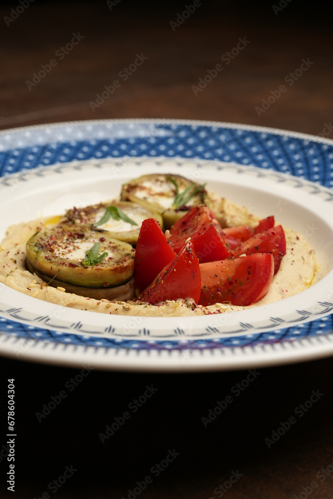 Vegan meal plate with fresh tomatoes, mashed potato and stuffed baked eggplant Vegan meal plate with fresh tomatoes, mashed potato and stuffed baked eggplant