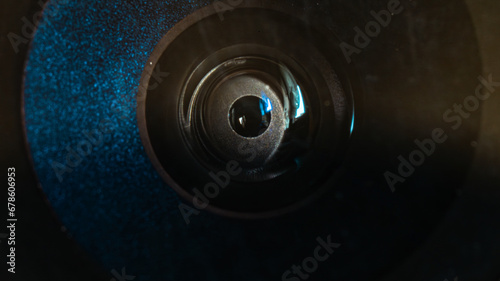 Round lens of a deteriorated mobile phone. Close-up photo of a smartphone camera lens, detaching plastic cover. Ultra macro photography. Electronic eye filming, artificial intelligence and control.