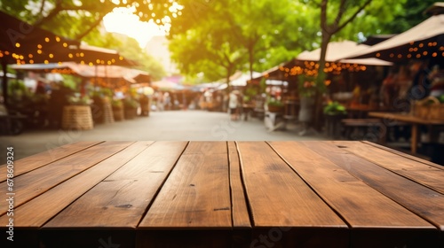 Wooden table with a background of a bustling street market  photo