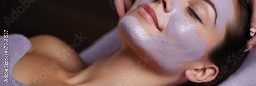 A professional masseuse applying a lavender-infused facial mask on a client for relaxation and skin rejuvenation relaxing spa background with empty space for text 