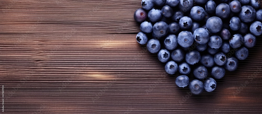 Heart shaped blueberry arrangement on wooden surface Heart shaped blueberry arrangement on wooden surface