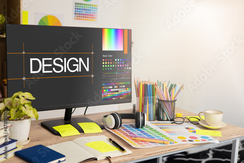 Graphic designer's workspace with a computer and creative tools on the table