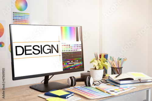 Graphic designer's workspace with a computer and creative tools on the table