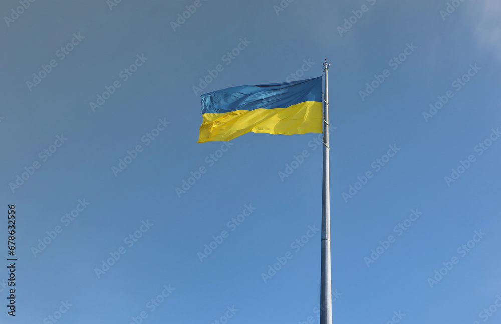 Ukrainian flag isolated on the blue sky with clipping path. Close up waving banner of Ukraine. Tall flag symbol of Ukraine, european country of freedom Ukrainian flag isolated on the blue sky with clipping path. Close up waving banner of Ukraine. Tall flag symbol of Ukraine, european country of freedom