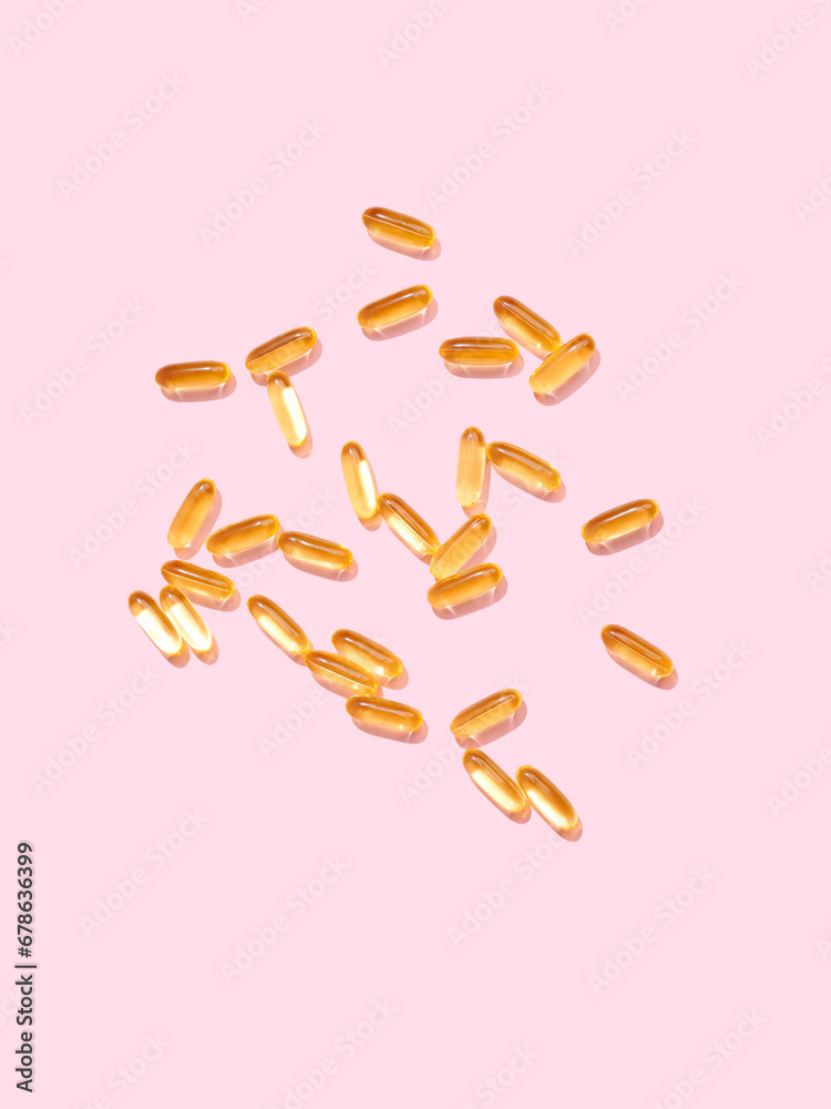 Flat lay Omega 3 golden translucent pills on flat background Flat lay Omega 3 golden translucent pills on flat background