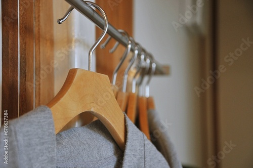 Bathrobe and Wooden Hangers in walk in closet