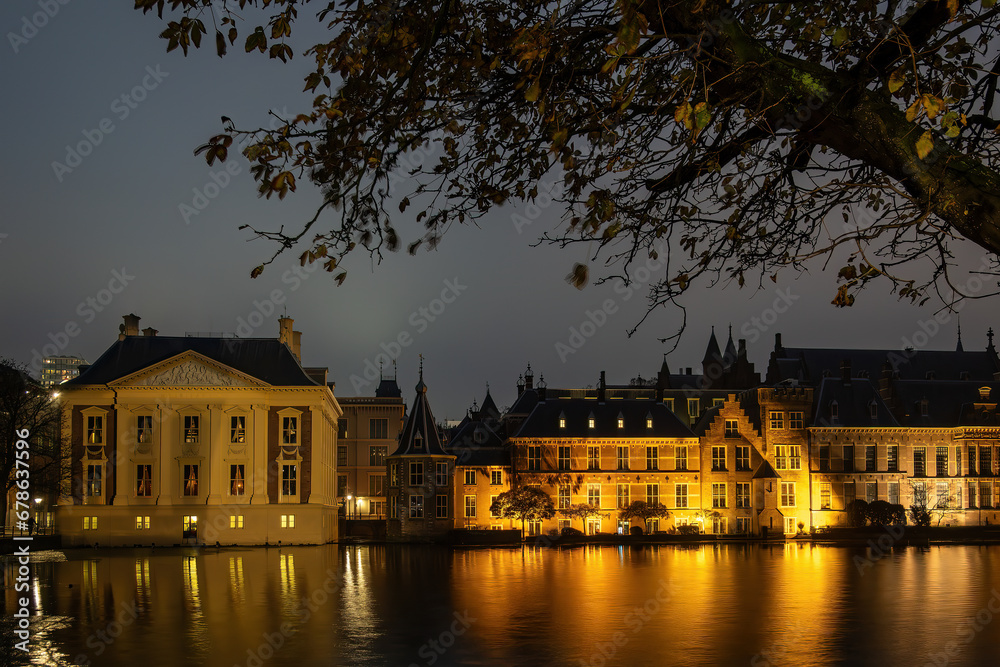 Fototapeta premium The Hague, Netherlands The Mauritzhuis Museum and the Dutch Parliament at night on the Hofvijver lake.