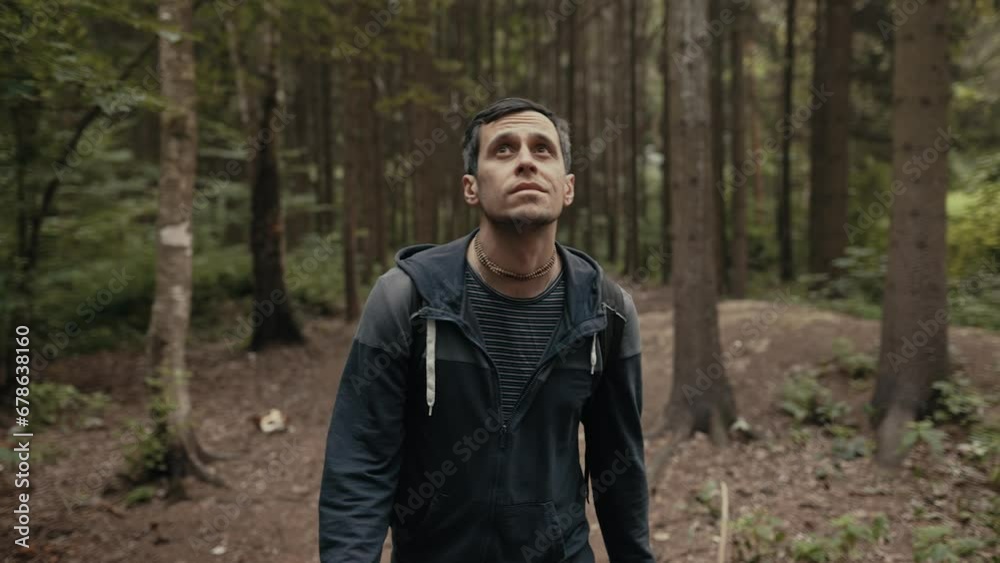 A man with a backpack walks through the forest A man with a backpack walks through the forest