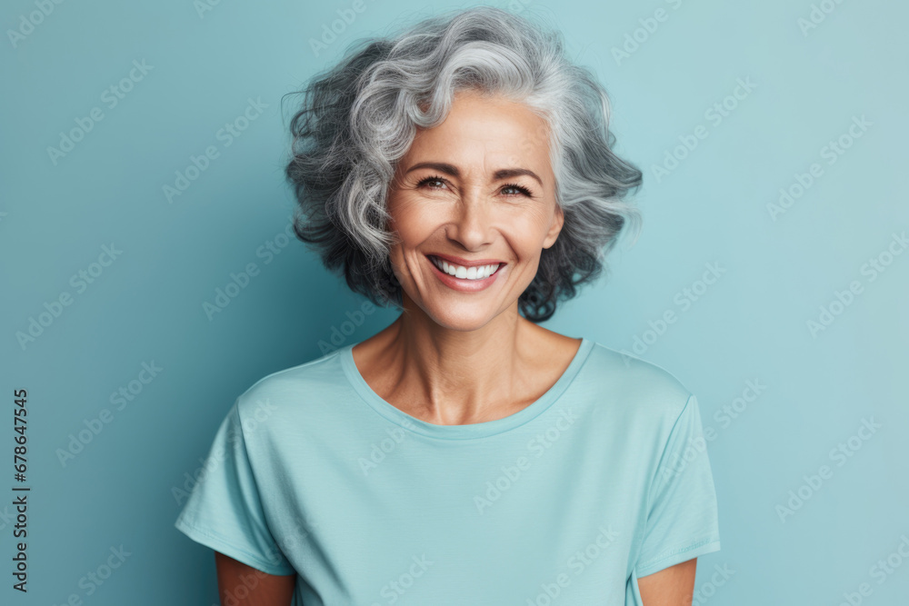 portrait of a smiling elderly woman with gray hair against blue background looking at the camera portrait of a smiling elderly woman with gray hair against blue background looking at the camera