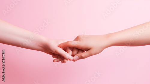 Two hands reaching each other in pink on the background