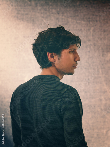 A man standing in front of a white wall