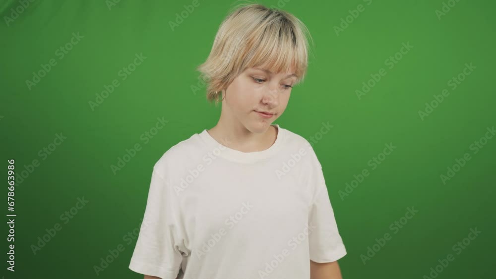 A teenage girl scratches her head and shrugs. Close-up. Isolated on a green background, chromakey. A teenage girl scratches her head and shrugs. Close-up. Isolated on a green background, chromakey.