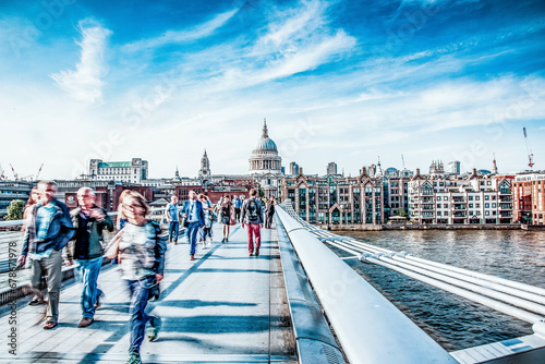 blurred image of people walking on Millenium bridge  London photo