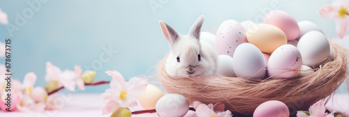 Easter banner with painted eggs and spring cherry blossom flower and cute little baby bunny rabbit on pastel background. Soft whimsical light with copy space.. #678673715