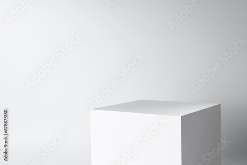 blank mockup template empty square box platform pedestal cube to display isolated white clean background with grey shadow wall © Daydreamaster