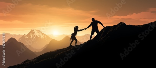 Help and assistance concept. Silhouettes of two people climbing on mountain and helping.